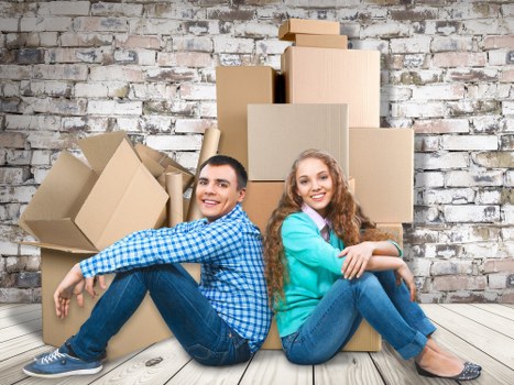 Moving team handling furniture in Sutton residential street