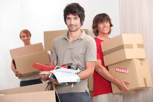 Removal team preparing furniture for transport in Sutton