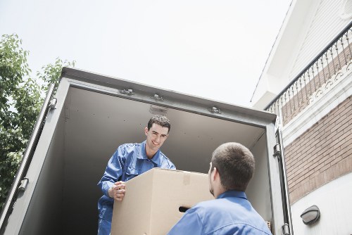 Trained removals crew carrying furniture with care