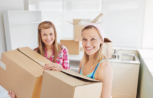 Local furniture pick-up service loading items safely for removal in Sutton